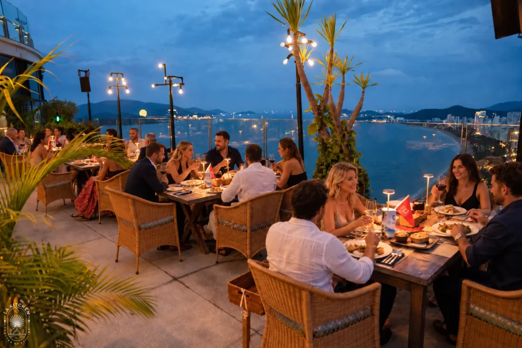Guests dining on the 43rd-floor rooftop at Skylight Nha Trang, overlooking Nha Trang Bay at dusk