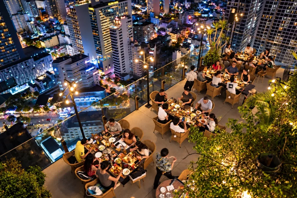 Year-end party Nha Trang - outdoor dining tables overlooking the city at Lá Kitchen, Skylight